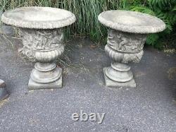 Urns on bases Cast stone Pair Classic English stoneware urns with cherubs